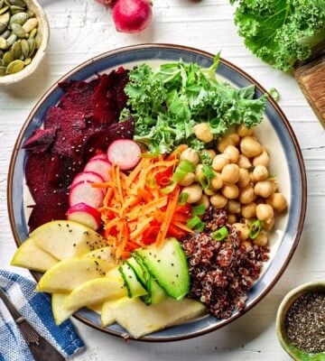Photo shows a colorful bowl of fresh fruit, vegetables, and salad