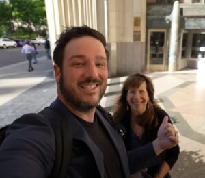A YouTuber and his mom speaking directly to camera on the street in a video reviewing Eleven Madison Park