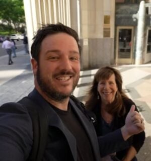 A YouTuber and his mom speaking directly to camera on the street in a video reviewing Eleven Madison Park