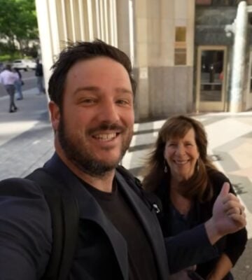 A YouTuber and his mom speaking directly to camera on the street in a video reviewing Eleven Madison Park