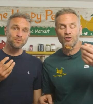The Happy Pear twins David and Stephen Flynn eating high protein vegan lasagna in a still from a YouTube video on the recipe