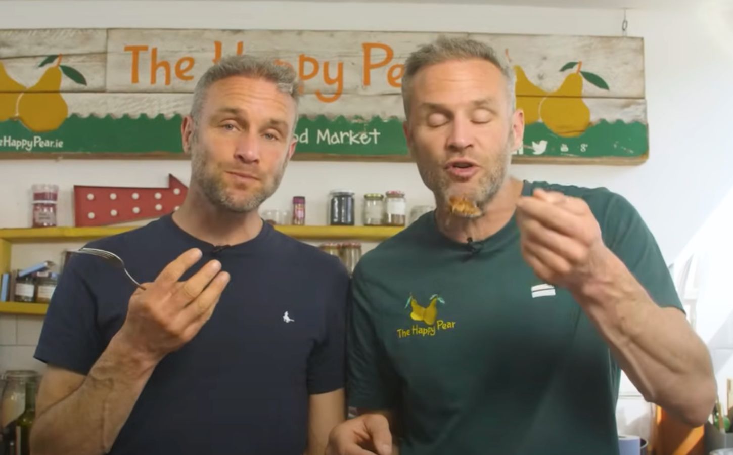 The Happy Pear twins David and Stephen Flynn eating high protein vegan lasagna in a still from a YouTube video on the recipe