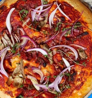 loaded focaccia slab with sun-dried tomatoes and artichokes