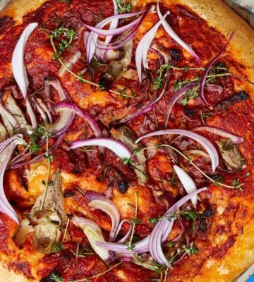 loaded focaccia slab with sun-dried tomatoes and artichokes