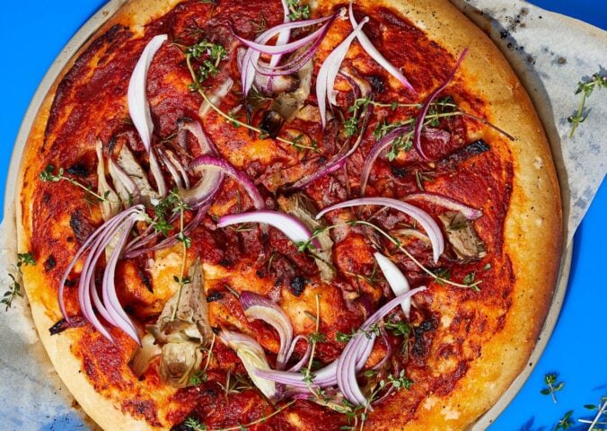 loaded focaccia slab with sun-dried tomatoes and artichokes