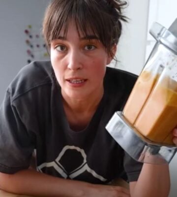 Merle O'Neal holding her romesco sauce in a blender for Tom Brady's high-protein vegan diet