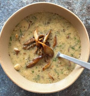 a vegan mushroom and white bean soup with lemon and tahini