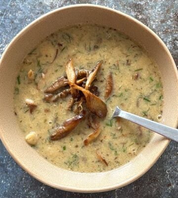 a vegan mushroom and white bean soup with lemon and tahini