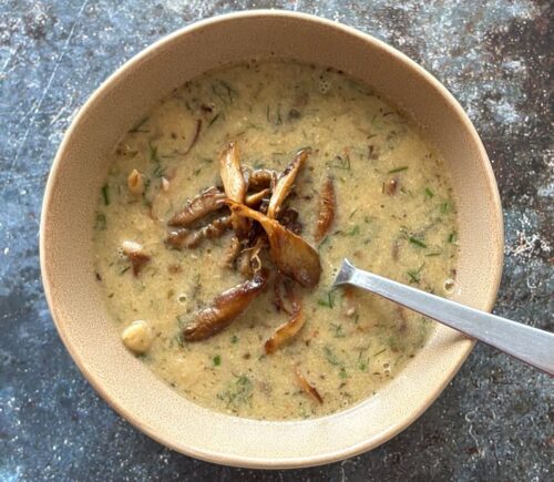 a vegan mushroom and white bean soup with lemon and tahini