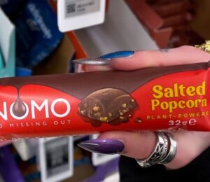 Photo shows one of the new NOMO vegan chocolate bar flavors, "Salted Popcorn"