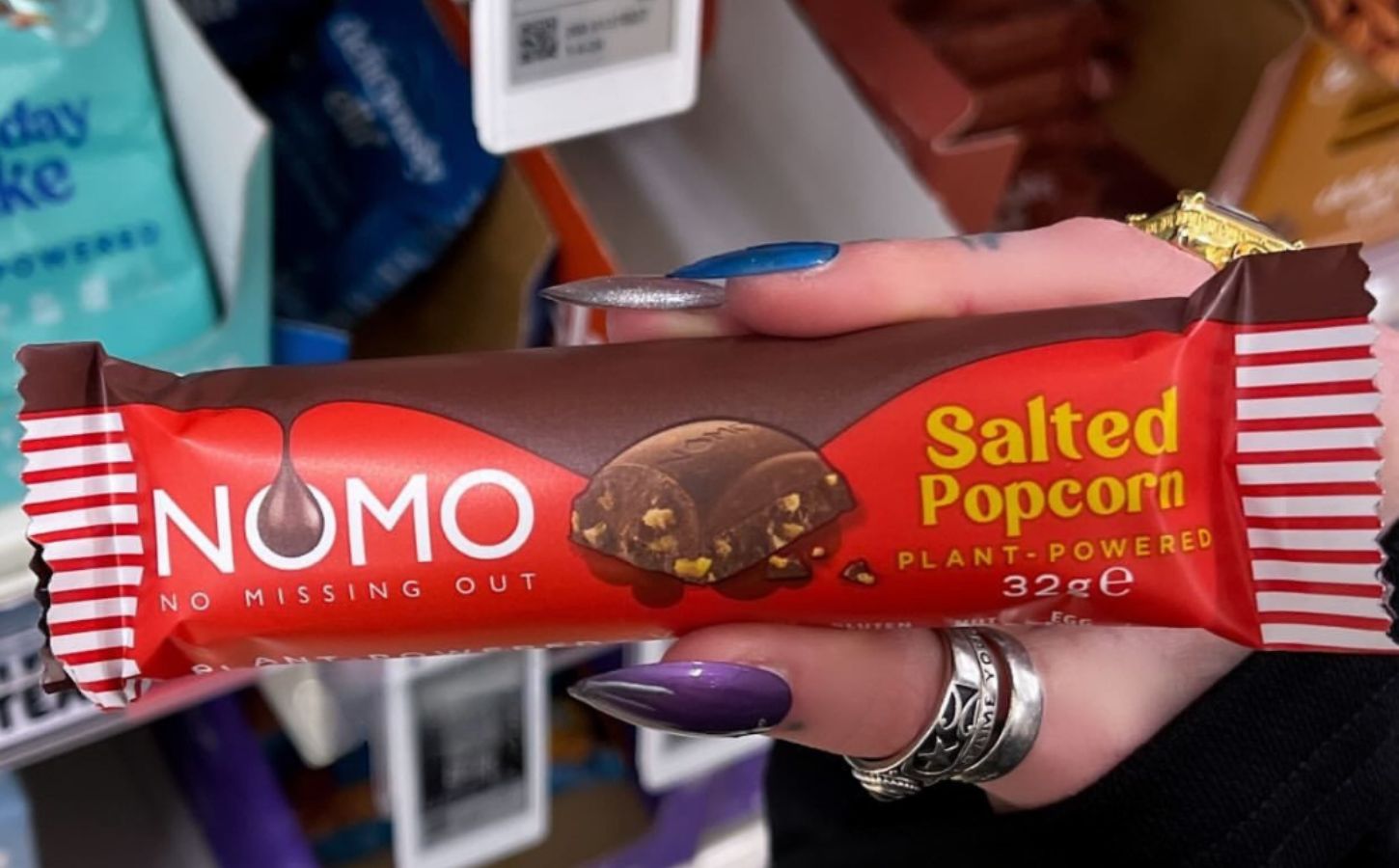 Photo shows one of the new NOMO vegan chocolate bar flavors, "Salted Popcorn"