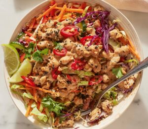 satay chickpea and quinoa salad with veggies and lime