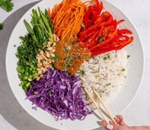 a beautiful bowl of spring roll salad with rice noodles and peanut dressing
