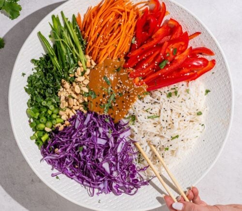 a beautiful bowl of spring roll salad with rice noodles and peanut dressing