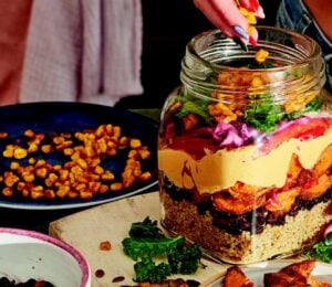 sweet potato rainbow salad with quinoa, corn. and cabbage