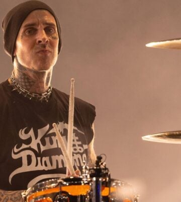 Blink 182 star and vegan celebrity Travis Barker playing the drums on stage
