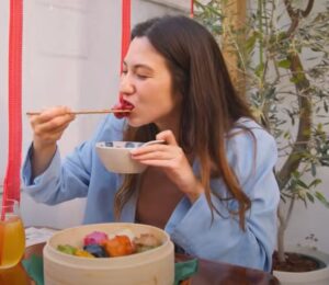 Shizuka Anderson, the host of Japan by Food YouTube channel, trying out vegan gyozas in a vegan guide to Japan video