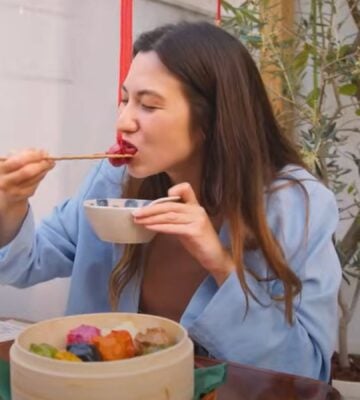 Shizuka Anderson, the host of Japan by Food YouTube channel, trying out vegan gyozas in a vegan guide to Japan video