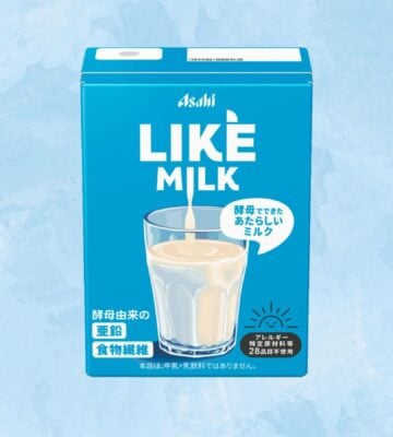 A carton of Asahi dairy-free milk in front of a blue background