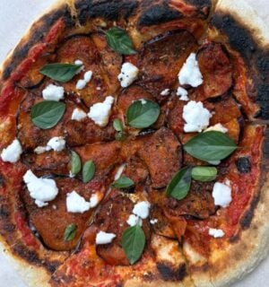 A vegan aubergine and harissa pizza with dairy-free feta cheese
