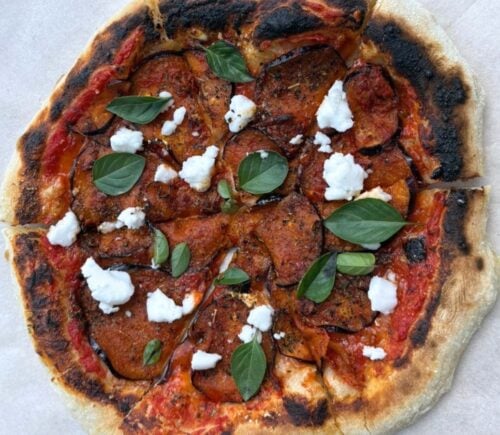A vegan aubergine and harissa pizza with dairy-free feta cheese