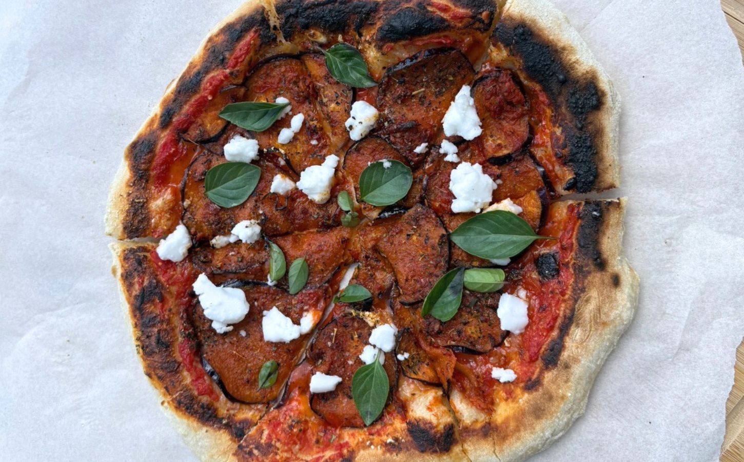 A vegan aubergine and harissa pizza with dairy-free feta cheese