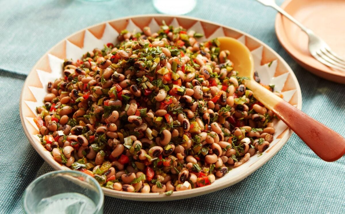 a plate of black-eyed bean salad with onion, bell pepper, and cornichons for vegan summer lunches