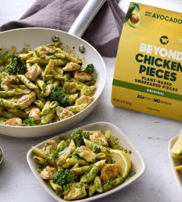 Photo shows several bowls of vegan broccoli pasta featuring the new Beyond Chicken Pieces, alongside the product's packaging