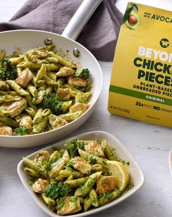 Photo shows several bowls of vegan broccoli pasta featuring the new Beyond Chicken Pieces, alongside the product's packaging