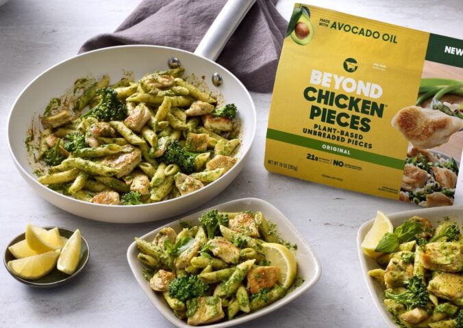 Photo shows several bowls of vegan broccoli pasta featuring the new Beyond Chicken Pieces, alongside the product's packaging