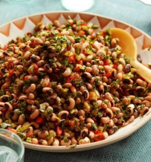 a plate of black-eyed bean salad with onion, bell pepper, and cornichons