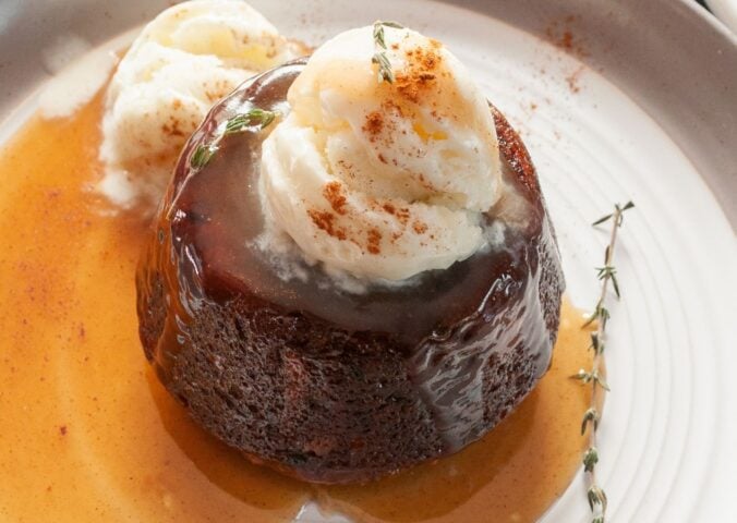 carrot cake sticky toffee pudding with vegan ice cream on top