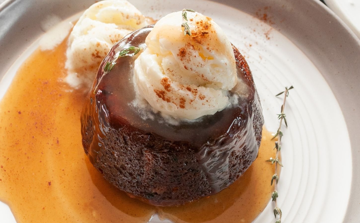 carrot cake sticky toffee pudding with vegan ice cream on top