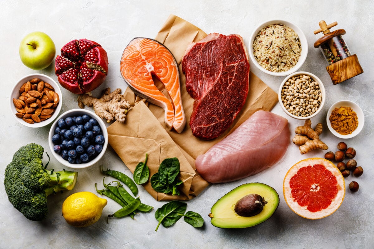 Photo shows a selection of plant-based foods mixed in with raw animal-derived foods like poultry, beef, and fish