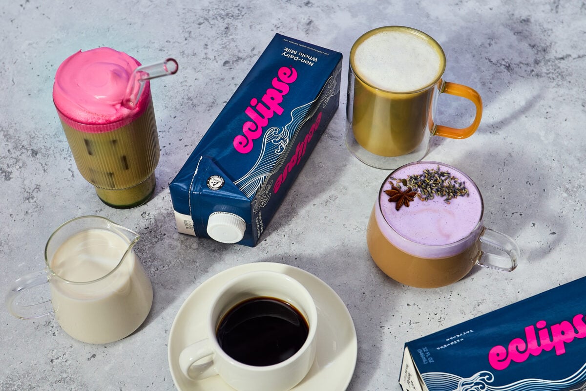 Photo shows a carton of the new plant-based whole milk from Eclipse Foods alongside different beverages made using it