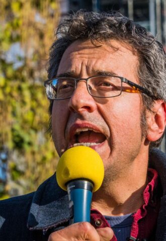 Photo shows journalist and activist George Monbiot speaking at a demonstration