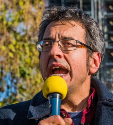 Photo shows journalist and activist George Monbiot speaking at a demonstration