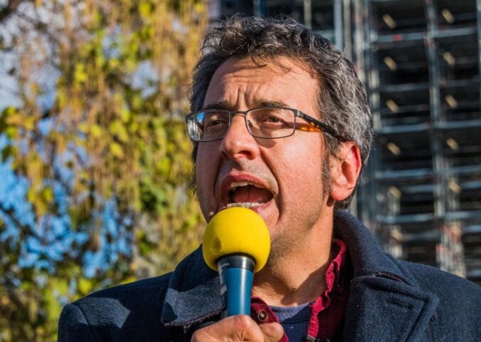 Photo shows journalist and activist George Monbiot speaking at a demonstration