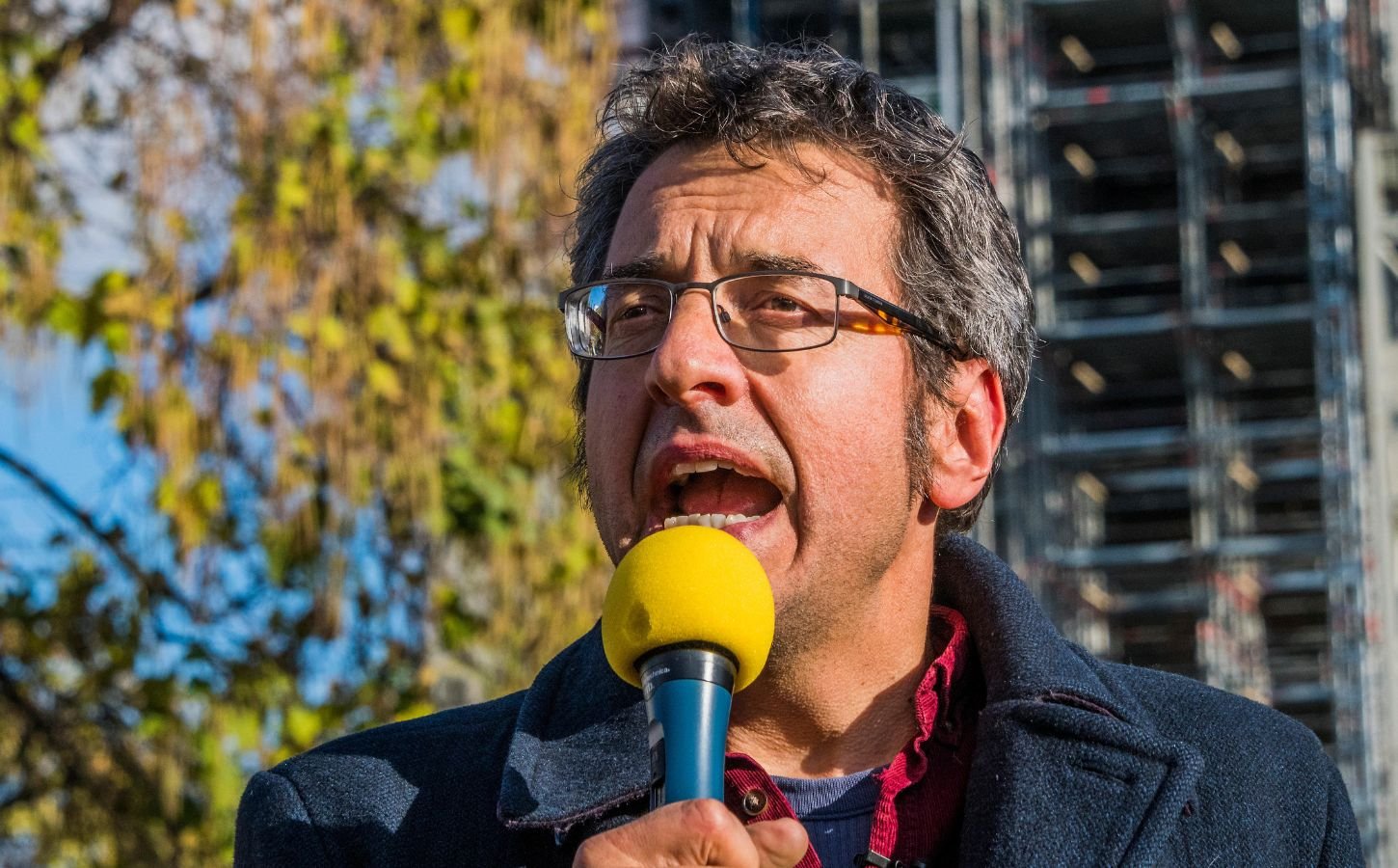 Photo shows journalist and activist George Monbiot speaking at a demonstration