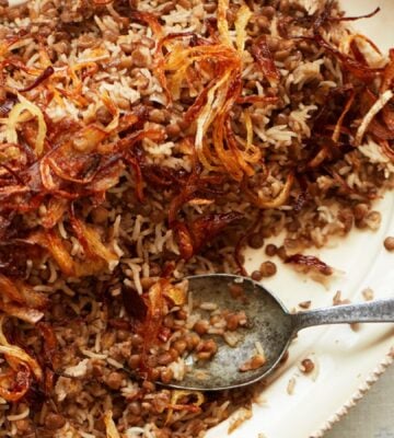 a bowl of lentils and rice with caramelized onions to share