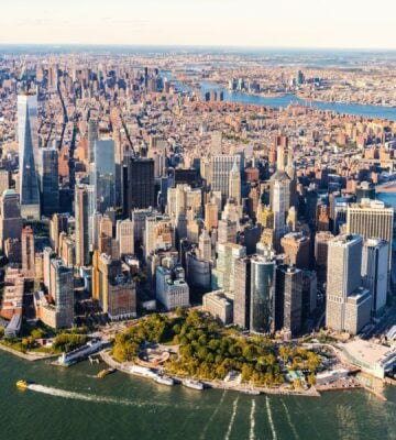 Photo shows an aerial view of lower Manhattan and the rest of the New York City skyline
