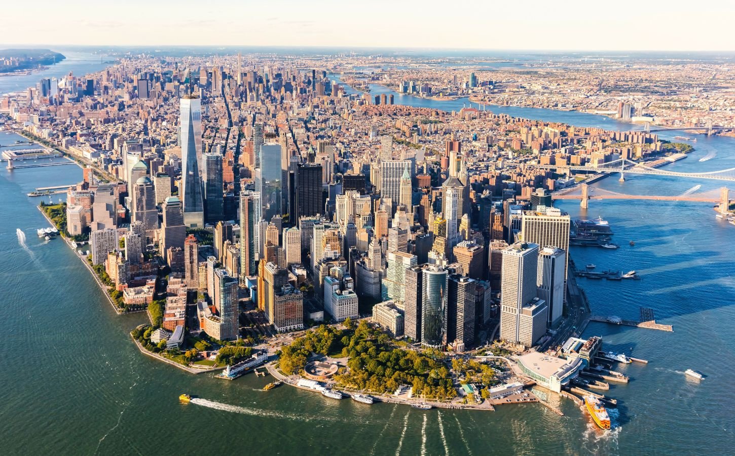 Photo shows an aerial view of lower Manhattan and the rest of the New York City skyline