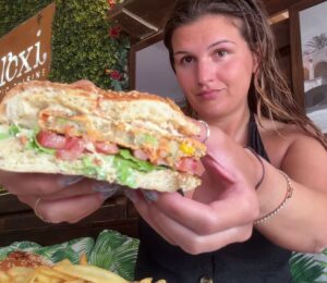 Nicole Whittle eating a vegan burger on her trip as part of the Mediterranean diet but make it vegan video