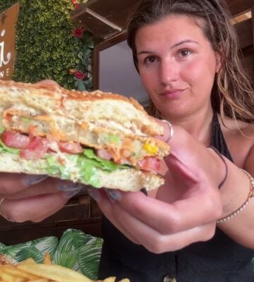 Nicole Whittle eating a vegan burger on her trip as part of the Mediterranean diet but make it vegan video