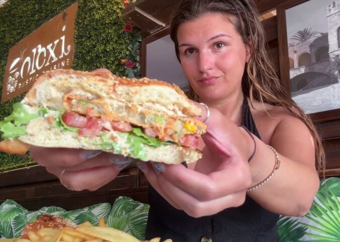 Nicole Whittle eating a vegan burger on her trip as part of the Mediterranean diet but make it vegan video