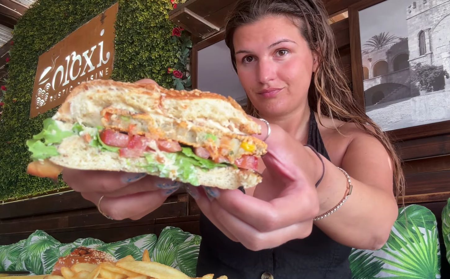 Nicole Whittle eating a vegan burger on her trip as part of the Mediterranean diet but make it vegan video