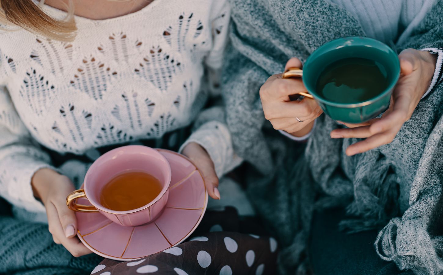 Photo shows two women drinking cups of herbal tea