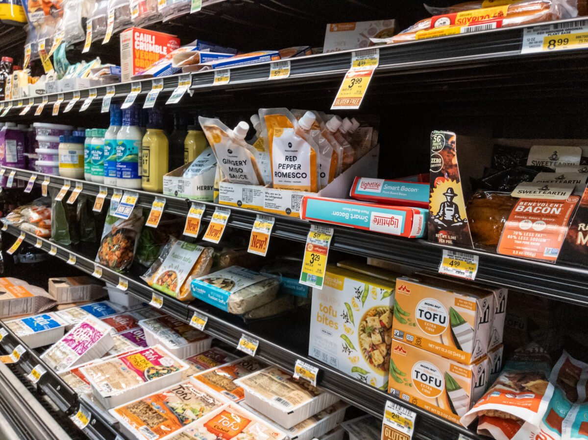 Photo shows a selection of alternative proteins including plant-based meat and tofu on supermarket shelves