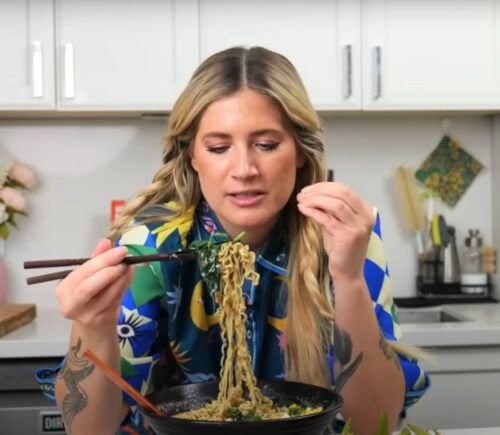 Candice Hutchings eats a bowl of ramen in a video featuring realistic high protein meals that she eats in a day