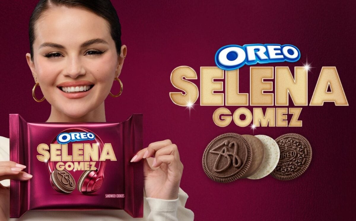 Photo shows Selena Gomez on a purple background holding up the new Oreo cookies she helped to design
